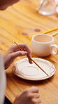 Hands, person and painting pottery in workshop for art, creative decoration or handmade craft. Paintbrush, pattern or potter with ceramic in studio for design, artistic process or small business