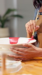Hands, woman and painting pottery in workshop for art, creative decoration or handmade craft. Paintbrush, person or potter with ceramic in studio for custom design, artistic process or small business