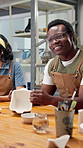 Happy, man and painting in art class with ceramics, discussion and bonding with friends on weekend. Social, person and creativity in workshop with paintbrush, clay product or conversation with hobby.