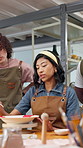 Instructor, people and painting in art class with ceramics, explain design or guidance for technique. Teacher, group and advice in pottery workshop with paintbrush, discussion or tips for creativity.