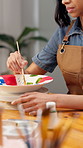 Creative, hands and painting pottery in workshop for art merchandise, productivity or handmade craft. Paintbrush, woman and potter with ceramic in studio for artistic manufacturing in small business