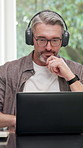 Headphones, laptop or man in home office with video call, funding review or advice in remote work. WFH, digital or mature finance advisor with tech, investment inquiry or discussion in online meeting