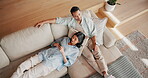 Couple, chilling and texting with phone in lounge, entertainment and bonding with partner in house. Watching tv, above and happy people with remote on couch, relax and message with mobile app in home