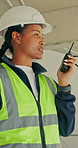 Engineer, woman and discussion at construction site with radio, coordination and supervisor advice. Person, talk and guidance in building with tech, engineering instructions and project management.