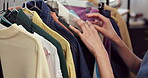 Shopping, rack and hands in store with clothes, garment choice and decision in trendy style. Retail, woman and customer in boutique with selection, outfit search and option for fashion purchase.