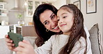 Daughter, mother and selfie with phone in home living room for bonding, family love or memories. Happy, photograph and relax with single parent woman kissing girl child in apartment for picture