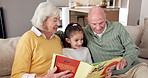 Love, grandparents or girl on couch with book, family storytelling or bonding in reading hobby. Happy, senior people or kid in house with story, quality time or connection in literature activity.