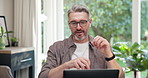 Remote work, video call and man with laptop in home office, paperwork and online coach with advice. Freelance, business advisor and mature person with earphones, happy and virtual meeting with tech
