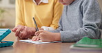 Homework, hands and grandparent with child in home for writing, study and learning for development. Family, house and kid with grandmother for help with assessment for education, knowledge and growth