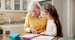 Home, grandma and child with homework for help, writing assessment and learning for development. Family, teaching and girl with grandmother, worksheet and support for education, knowledge and growth