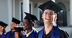 Graduation, face and man on campus with crowd, academic success and pride at college farewell. University, happy and student with laugh, accomplishment and educational achievement at degree ceremony.