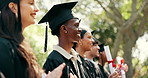 Man, students and diploma at campus at graduation, speech and celebration of degree completion. People, applause and graduate outdoor with regalia, university recognition and educational milestone