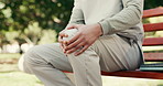 Hands, person and medical student with knee pain outdoor, injury and inflammation with arthritis. Healthcare discomfort, sore leg and nurse on park bench at college campus, fibromyalgia or strain