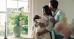 Parents, baby and kiss in living room with love, adoration or family connection for bonding together. Happy people, mother and father in home with infant daughter, affection and nurture for growth.