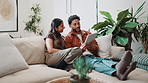 Happy, couple and discussion in home with tablet, online shopping opinion or browse website together. Married people, relax and conversation on couch with tech, ecommerce app and internet search.