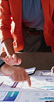 Hands, person and graphs in meeting with documents, data analysis and finance report for profit. People, collaboration or review in office with statistics, kpi results and charts for financial growth