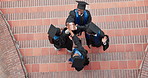 Graduate, celebration and happy people at event, high five and excited friends with academic growth. University students, above and applause for graduation ceremony, support or laugh with achievement
