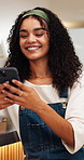 Happy, woman and typing in coffee shop with phone, social media and online dating chat notification. Customer, person relax and smile in cafe with tech, mobile app and connectivity for text message.