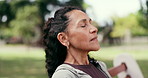 Mature, woman and breathing on park bench for outdoor peace, quiet or fresh air in nature. Relax, female person or thinking with calm wind or breeze for healthy ambition, mindfulness or wellness