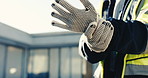 Hands, construction worker and gloves at site for safety, injury prevention or work preparation. Person, protection compliance or getting ready with PPE outdoor for development, building gear or clap