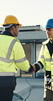 Technician, handshake and meeting at site with construction worker, intro and discussion for project. Men, builder and shaking hands outdoor with electrician for welcome, plan and talk about building