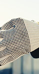 Outdoor, closeup and hands with gloves on construction site, civil engineering or safety compliance. Engineer, protection and person with PPE, architecture and ready renovation projection on roof
