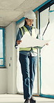 Engineer, woman and inspection at construction site with blueprint, plan and check safety of design. Low angle, person and supervisor in building with layout document, engineering or problem solving.