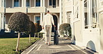 Back, man and walk outdoor with suitcase, check in and accommodation for holiday abroad. Thinking, mature person and arrival at hotel with luggage, guest service and resort entrance on vacation trip