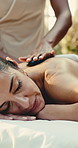 Hands, massage and woman at spa with hot stone, deep tissue and treatment for muscle tension. Masseuse, mature person and detox at salon with warm rocks, healing and thermal therapy for body wellness