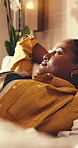 Tired, woman and relax in hotel room with vacation, travel fatigue or thinking for peaceful getaway. Calm, person and tourist holiday in lodge with jet lag exhaustion, reflection and rest on bed.