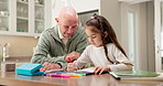 Coloring, homework and child with grandpa in home, skill development or learn with creative project. Senior man, talk and kid with assignment, happy family and cognitive growth with crayon in house