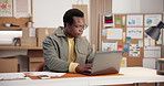 Ecommerce, man and typing in office with laptop, check paperwork or data collection for online order. Black person, reading and stats analysis in small business with computer, document or sales info.