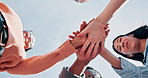 People, applause and huddle with hands together for winning, community achievement or success. Low angle, group or happy students piling with stack or smile for academic achievement or teamwork