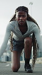 Serious, woman and start running in city with fitness, intense workout or endurance training outdoor. Face, black person and runner on road with wellness, begin sprint and exercise in urban town.