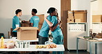 Volunteering, hug or team in center with greeting, friendly hello or preparing for donation campaign. Happy, friends or people with welcome embrace, appreciation or outreach support for food drive.
