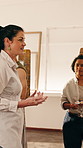 Teacher, people and talk in art class with painting advice, creative insight or project instructions. Woman, speaking and teaching students in artist workshop with lesson, guidance or tips for craft.