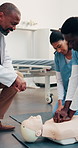 Doctor, dummy and people at hospital for cpr, demonstration and medical course for critical care. Teacher, supervision and nurses in clinic with mannequin, training students and resuscitation process