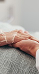 Doctor, holding hands and patient in clinic for comfort, empathy and prognosis of health update. Surgeon, console or person in hospital for support, compassion and medical recovery of chronic illness
