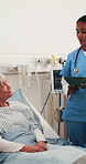 Talking, medical team and senior woman in hospital bed, tablet or care plan with recovery folder. Ward, nurse and doctor with elderly patient for healthcare, tech or smile for rehabilitation progress