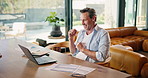 Mature, man and winning with laptop in home for financial profit, good news or achievement. Happy, male person or success with fist pump, documents or computer for finance, revenue or investment