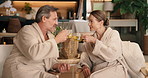 Herbal tea, couple and cheers at spa for relax, talk or pointing at scenery at anniversary for love. Drinks, mature man or woman toast for celebration at luxury resort, smile or vacation with partner