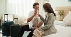 Couple, relax and cheers at hotel with alcohol, guest arrival and celebration for romantic holiday. Happy, mature people or toast at resort with champagne, complimentary gift and anniversary vacation