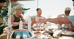 Candles, lunch and friends outdoor with meal, wine or bonding together for peaceful summer vacation. Mature people, eating food and relax on patio with alcohol drinks, candlelight or social gathering