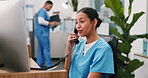 Phone call, happy and receptionist by computer in hospital for administration, search or telehealth. Person, nurse or medical assistant at desk for communication, appointment and clinic schedule