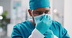 Face mask, surgeon and man in hospital for hygiene, wellness and safety compliance. Thinking, medical professional and healthcare with ppe, scrubs and surgery employee for risk support in clinic