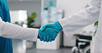 Doctor, meeting and team with handshake in hospital for medical procedure or partnership together. People, healthcare workers or shaking hands with greeting for b2b, merger or onboarding surgery