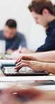 College, hands and student on laptop in classroom for learning, lesson and typing for course notes. University, computer and person in lecture for education, knowledge and studying for assignment