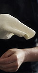 Person, hands or tossing with dough in studio for culinary art or hospital on a dark background. Pastry chef, pizza or artist with baking mixture, ingredients or meal prep for food, recipe or cuisine