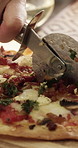 Person, hands and cutting board with pizza for fast food, dining recipe or meal prep in home. Pastry chef, cutter and slice with ingredients, dairy snack or cuisine for ready baked dinner in house