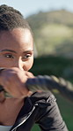 Fitness, action or athlete with battle ropes, outdoor workout or strength training in power routine. Intense, serious or black woman with equipment, resistance exercise or endurance for muscle growth